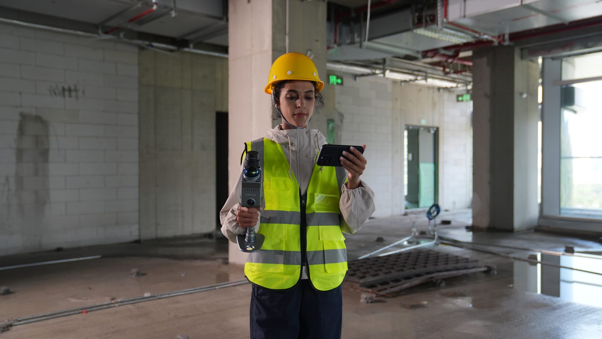Field technician scanning an unfinished building interior